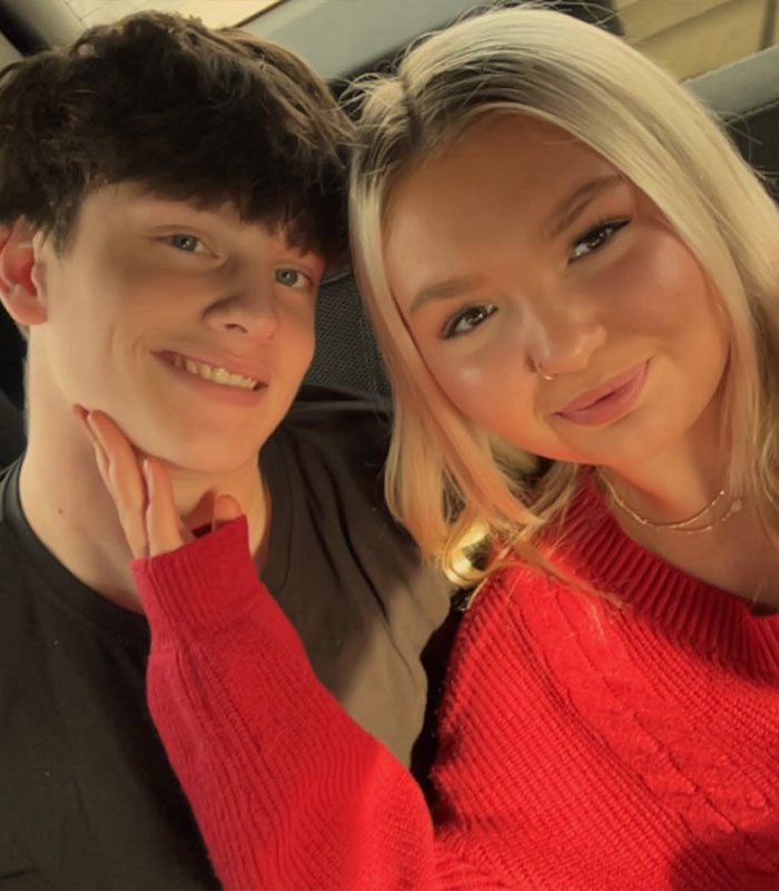 Teen couple sitting closely together, smiling at camera, highlighting the surprising update on controversial pregnancy case.