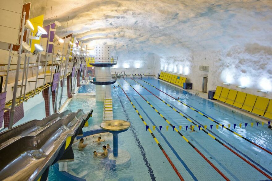 Indoor swimming pool inside an underground city cave, showcasing unique architecture and recreational facilities.