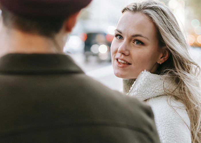 Woman talking to a man outdoors, capturing a moment that reveals who they really were after divorce.