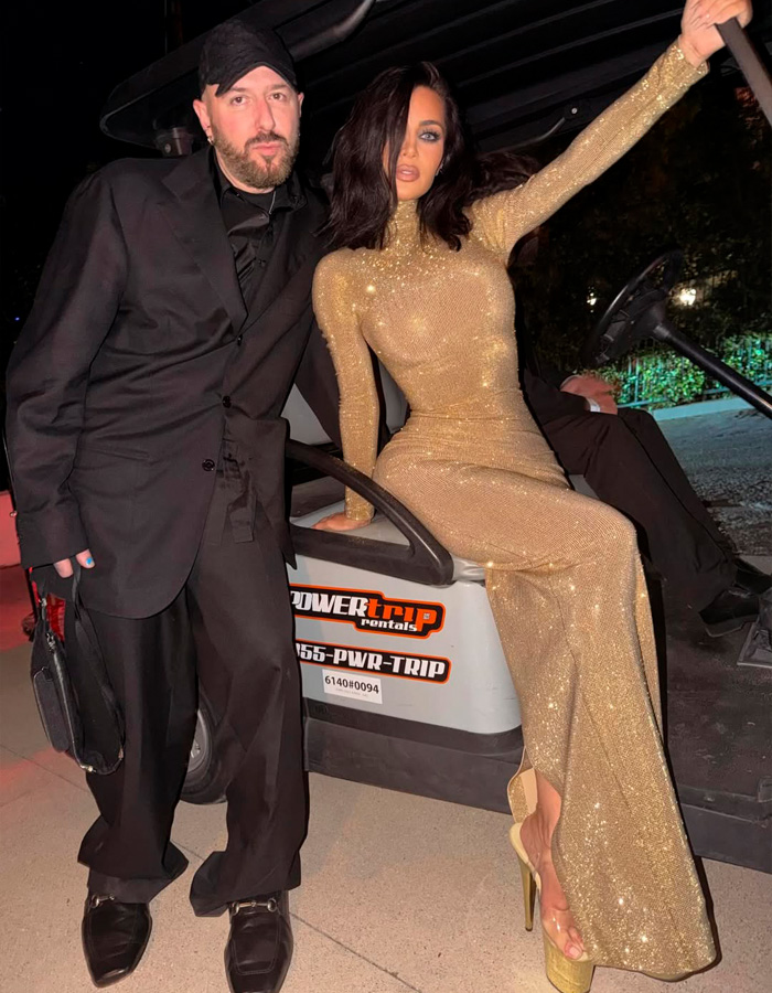 Kim Kardashian at Oscars party wearing a sparkling gold dress, fans react wildly to her look and odd details.