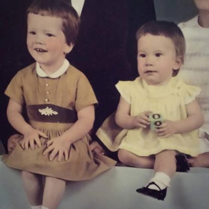 Two young children sitting together, showcasing vintage outfits and early childhood hair disasters.
