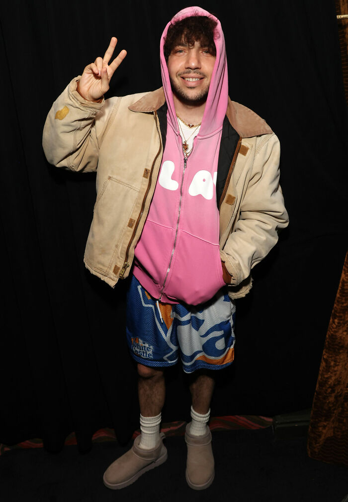 Man posing in a casual oversized jacket and shorts outfit, showcasing one of the biggest fashion fails of 2026 award season.