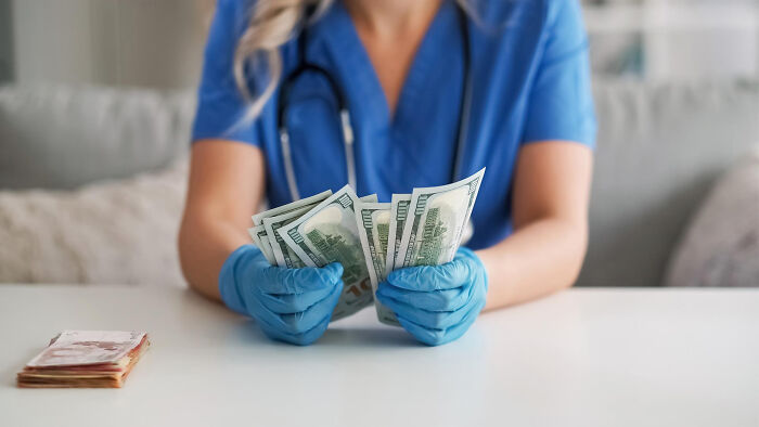 Medical professional wearing gloves counting cash, symbolizing what doctors prefer to hide from patients.
