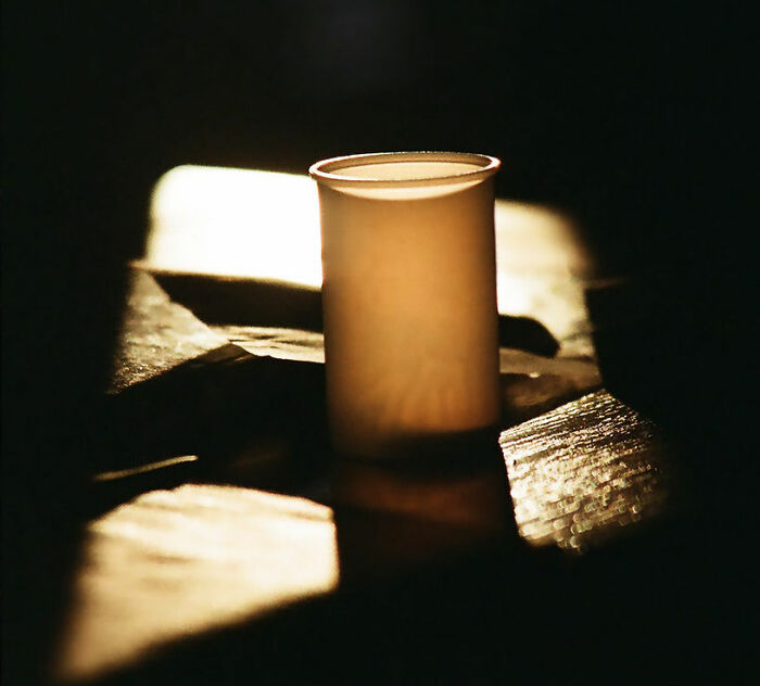 Close-up of a dimly lit cup on a table representing a California teacher suspended after bizarre classroom act secretly filmed.
