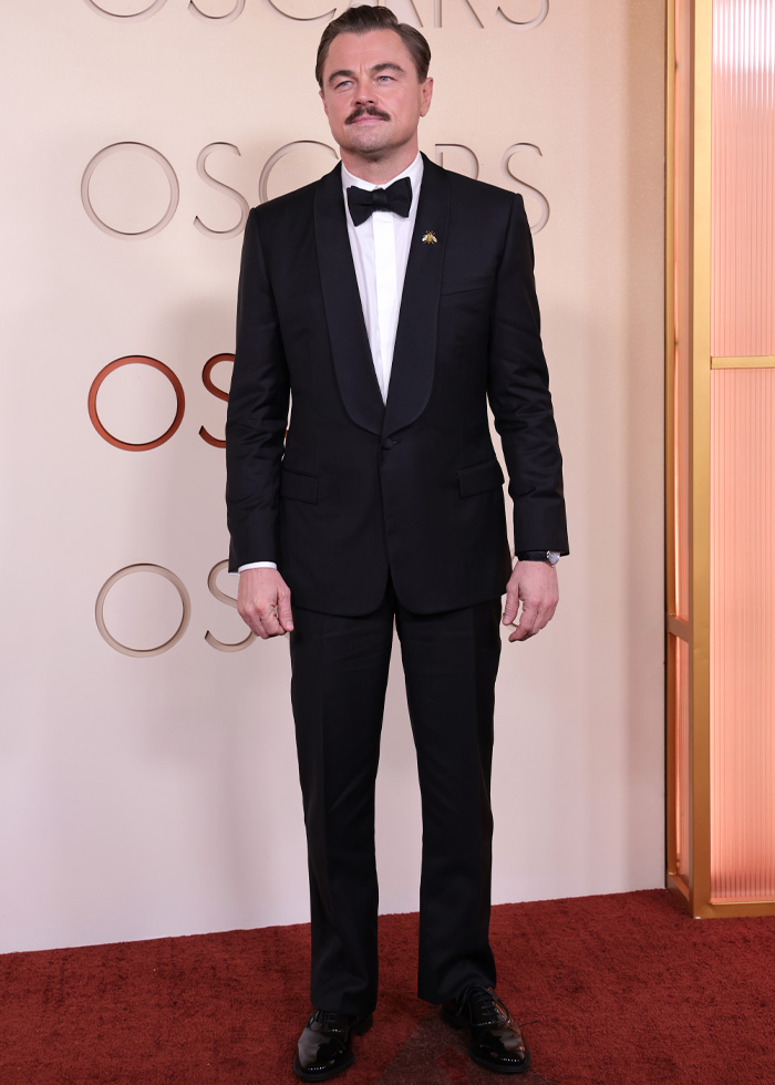 Actor in a classic black tuxedo with bow tie on the red carpet showcasing jaw-dropping outfits from Oscars 2026 event.