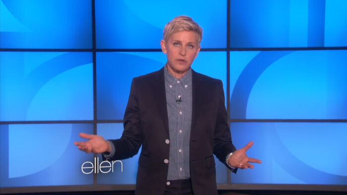 Ellen DeGeneres on a blue-lit stage, expressing feelings related to celebrities people used to like but now hate.