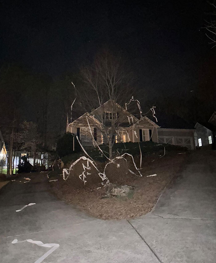 House covered in toilet paper at night illustrating students' prank on teacher that went tragically wrong with a shocking family decision.