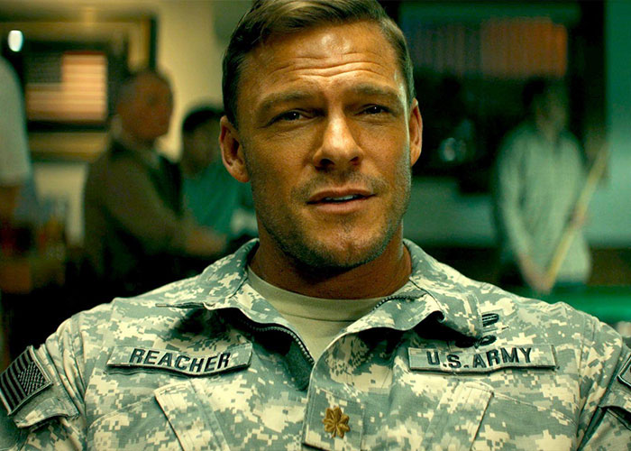 Reacher star Alan Ritchson in military uniform, sitting indoors with a focused expression during filming.
