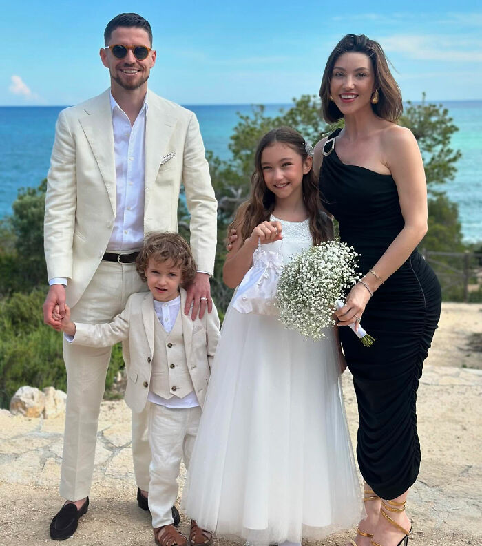 Family dressed formally outdoors by the sea, illustrating Jude Law's ex and Chappell Roan bodyguard dispute keywords.