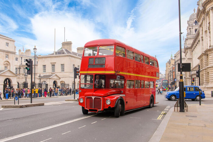 Red double-decker bus on a busy London street, part of bizarre encounters that left people questioning what they saw.