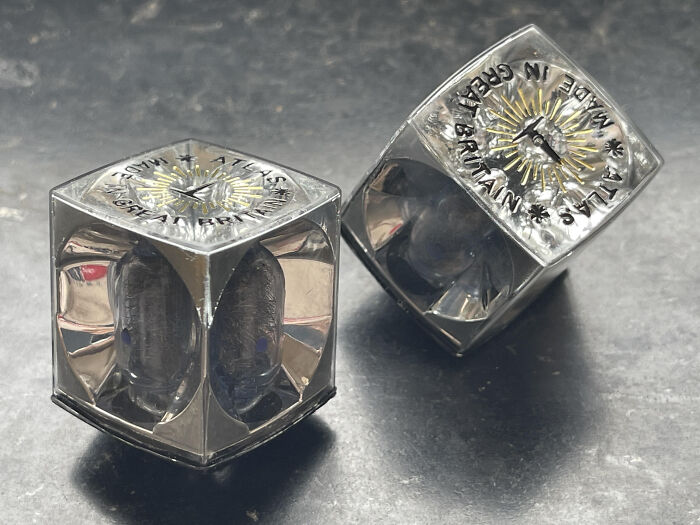 Two metal kaleidoscope cubes with "Made in Great Britain" text, an example of unidentified objects solved by the internet.