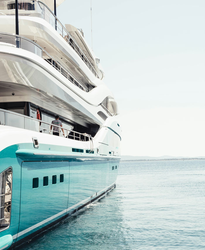 Luxury yacht docked at sea, illustrating corporate secrets behind high-end customer experiences and exclusive services.