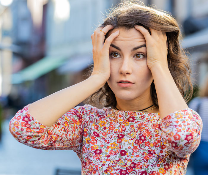 Young woman looking frustrated and stressed outdoors, illustrating bride furious at sister working out and looking good at wedding. Young woman looking frustrated and stressed outdoors, illustrating bride furious at sister working out and looking good at wedding.