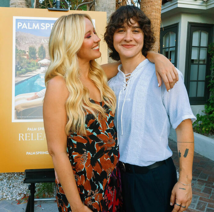 Anna Camp with partner smiling outdoors, highlighting age-gap romance and sexuality clarification in a casual setting.