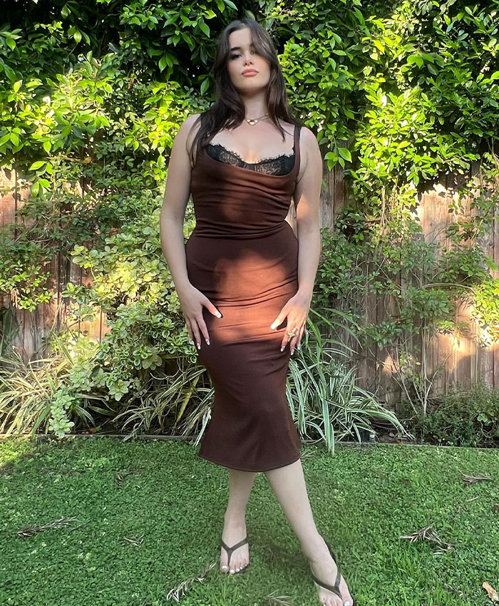 Barbie Ferreira posing outdoors in a brown dress, highlighting her dramatic transformation sparking heated debate.