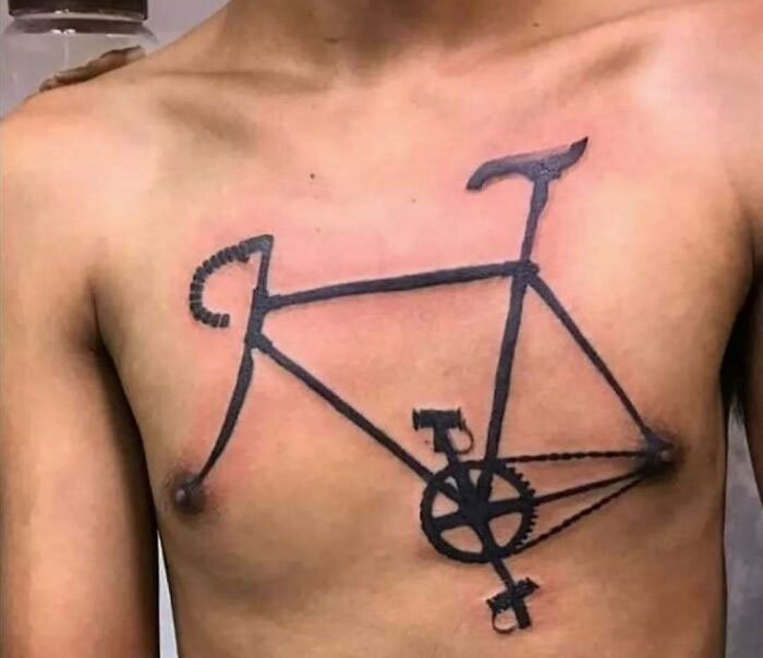 Tattoo fail showing a poorly drawn bicycle on a person's chest, illustrating a permanent ink regret.