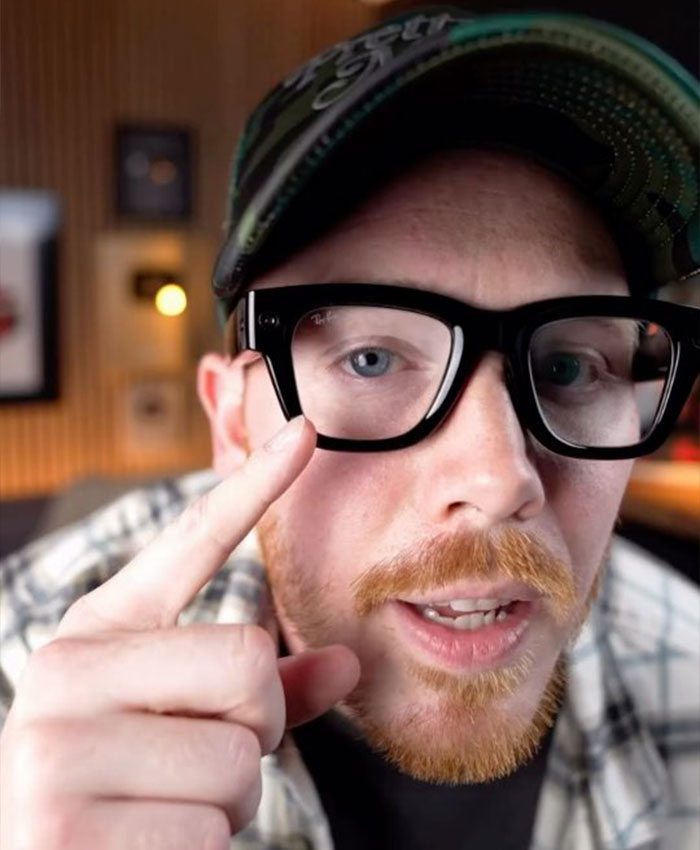 Man wearing smart glasses explaining disturbing things seen by Meta workers through users' smart glasses in an indoor setting.