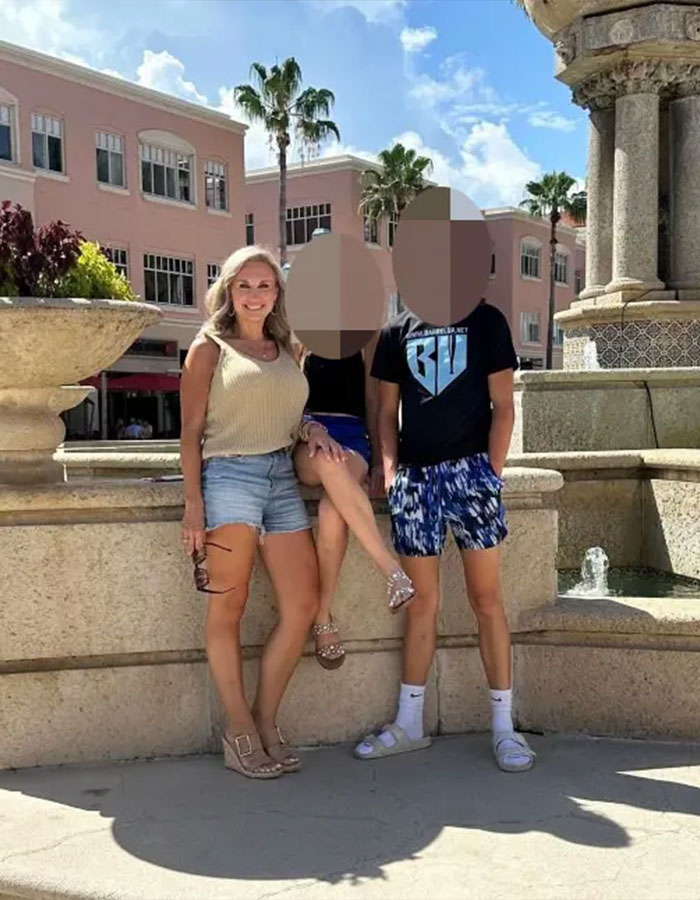 Former Mayor Misty Roberts posing outdoors with two people, palm trees and buildings in bright daylight background