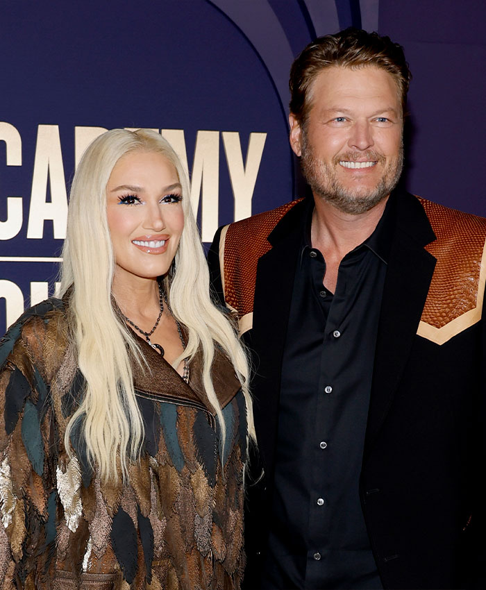 Gwen Stefani smiling with long blonde hair wearing a patterned jacket, addressing her Christian pivot in a public event.