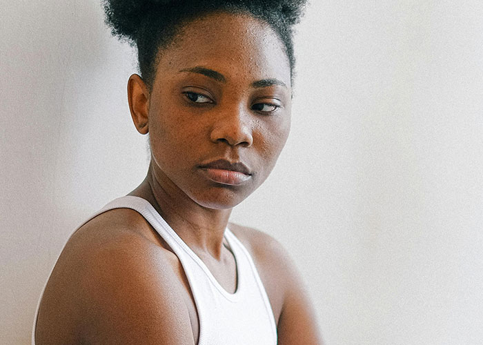 A woman looking away pensively, capturing the moment of realizing her ex revealed who they really were.