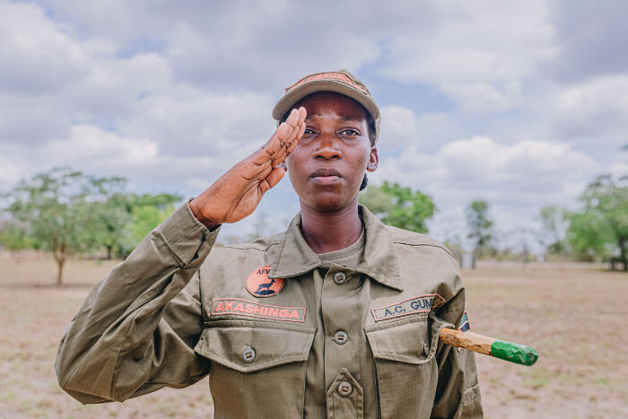 Woman in military uniform saluting outdoors, representing ladies who chose power tools and lab coats over manicures