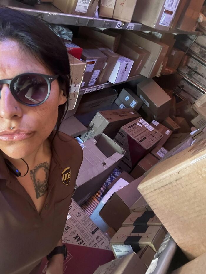 Woman in UPS uniform surrounded by stacked packages showing ladies choosing power tools and lab coats over manicures.