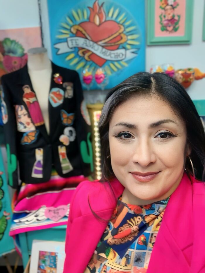 Portrait of a confident woman in colorful attire, representing women who chose power tools and lab coats over manicures.