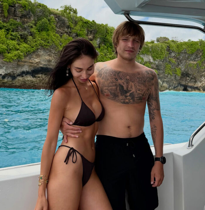 Young couple on a boat near Bali cliffs, linked to horrifying discovery after wealthy businessman's ransom video incident.