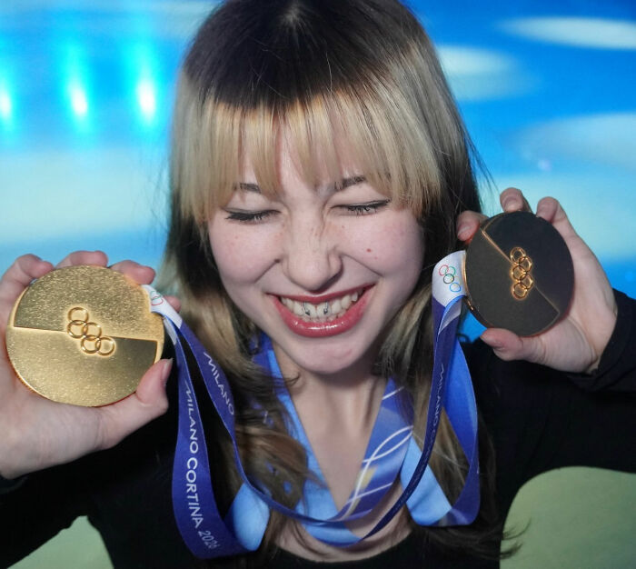 Young figure skater holding Olympic medals and smiling, highlighting challenges behind Alysa Liu's figure skating retirement.
