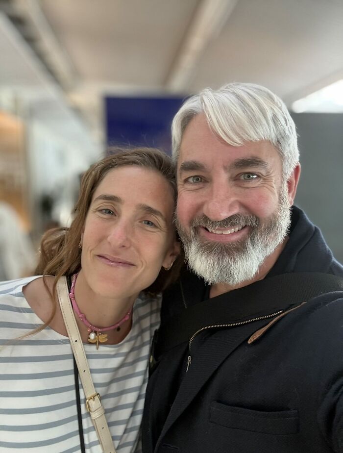 Smiling middle-aged couple close together indoors, capturing a one-in-a-million story moment with a warm and genuine vibe.