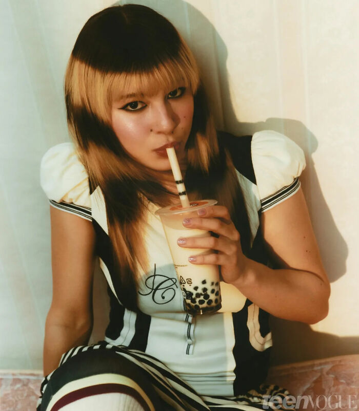 Alysa Liu drinking bubble tea indoors, highlighting Olympic hero figure skating challenges and surprising retirement reasons.