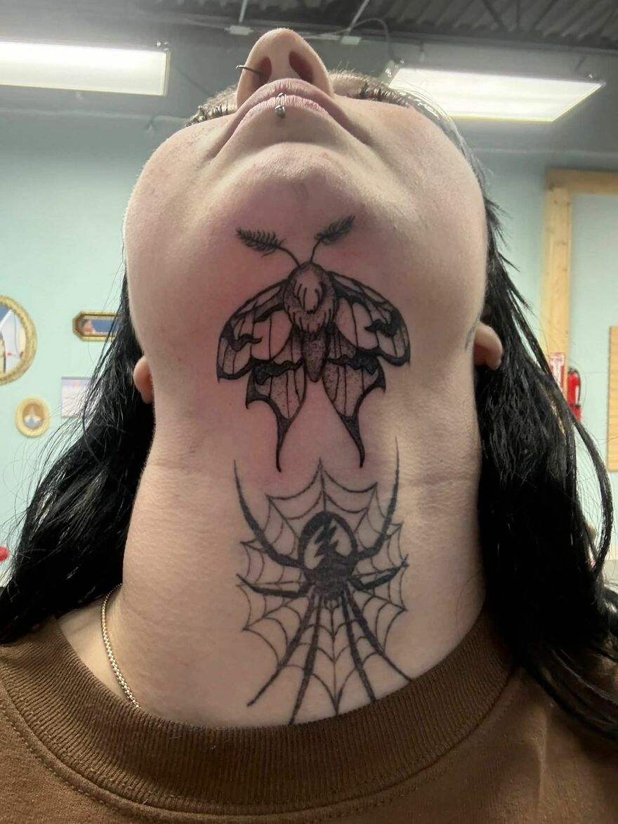 Neck tattoos featuring a moth and a spider with web, showcasing unusual and bold tattoo art on skin.