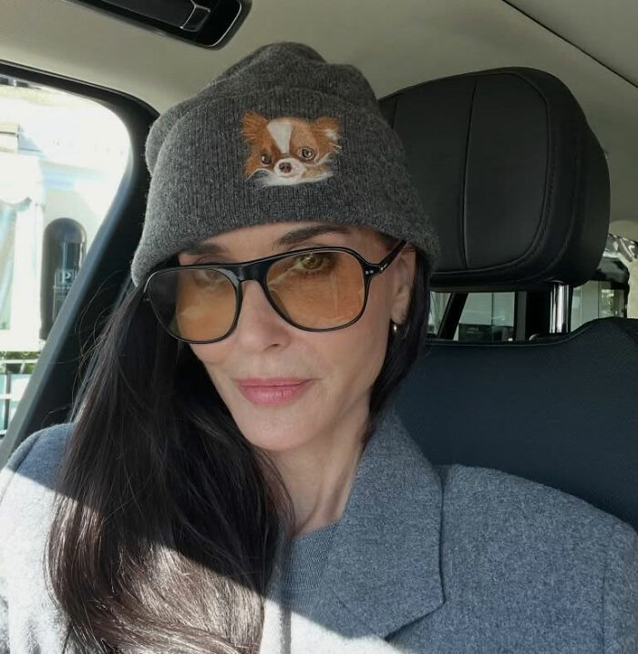 Demi Moore wearing sunglasses and a gray beanie inside a car, sparking discussion over her weight loss at SXSW.