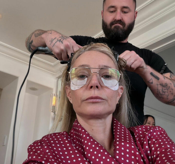 Gwyneth Paltrow getting her hair styled wearing glasses and eye patches before wearing risky Oscars dress with malfunction issues.