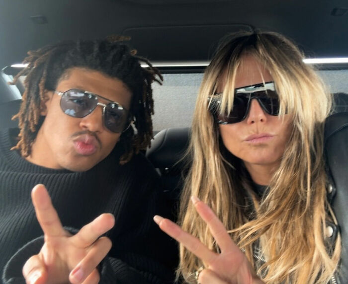 Heidi Klum and her son posing with sunglasses and peace signs, showcasing star-like looks together. Heidi Klum and her son posing with sunglasses and peace signs, showcasing star-like looks together.