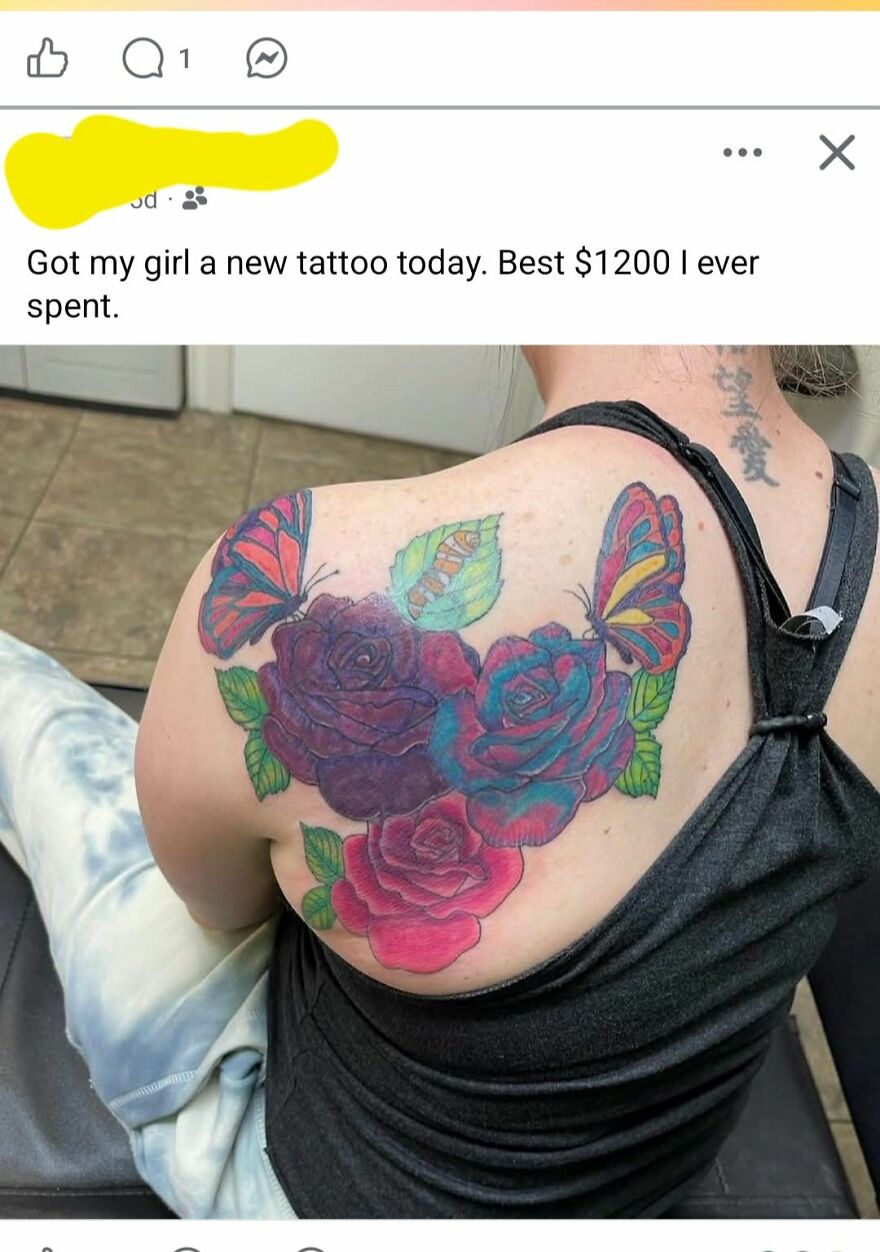 Colorful butterfly and rose tattoo on a person's back, showcasing unique tattoo art and design details.