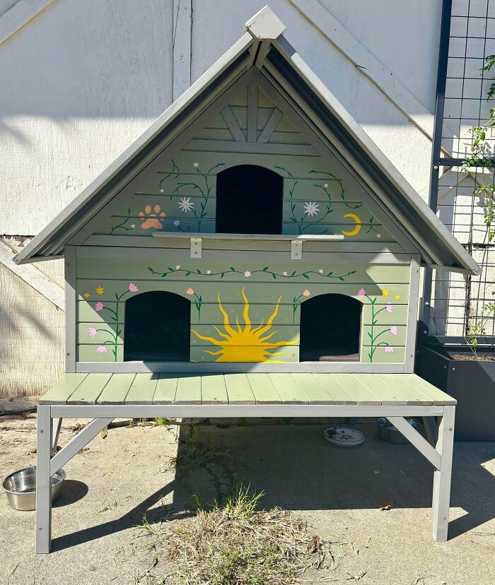 Handcrafted DIY pet house painted with sun, flowers, and moon designs, showcasing creative DIY wins and healing projects.