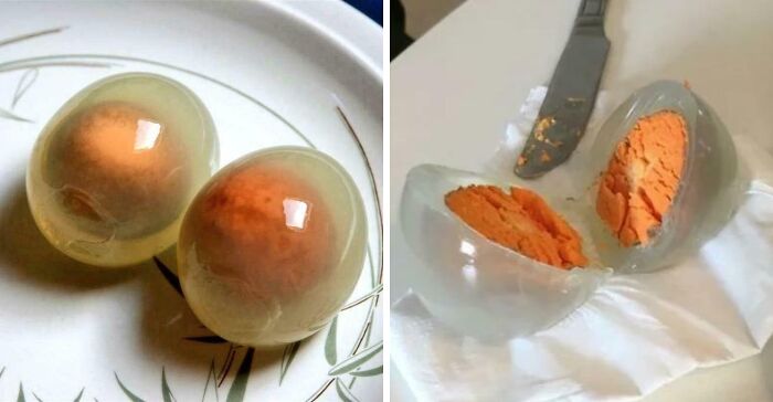 Two translucent eggs with bright orange centers on a plate, showcasing unreal photos of incredible reality.