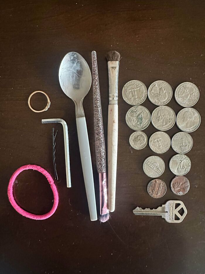 Various small items found by a great dad, including coins, a spoon, a key, and a hair tie.