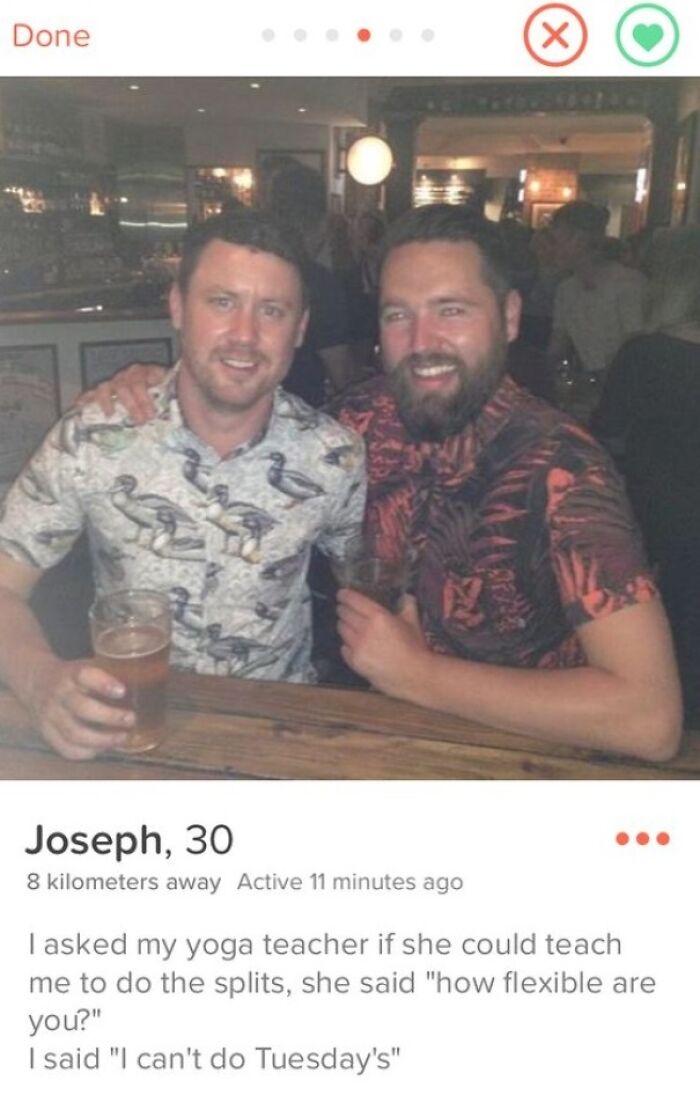 Two men smiling at a bar with a humorous Tinder profile joke about yoga flexibility and doing the splits.