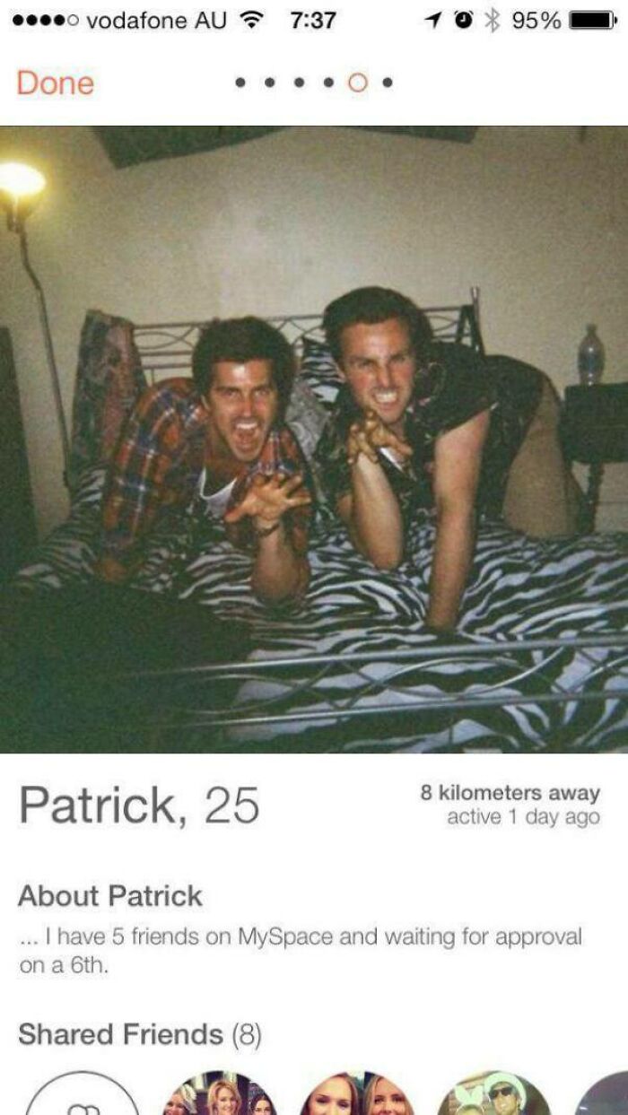 Two men posing playfully on a bed in a funny Tinder profile, highlighting humorous and cringe dating moments.