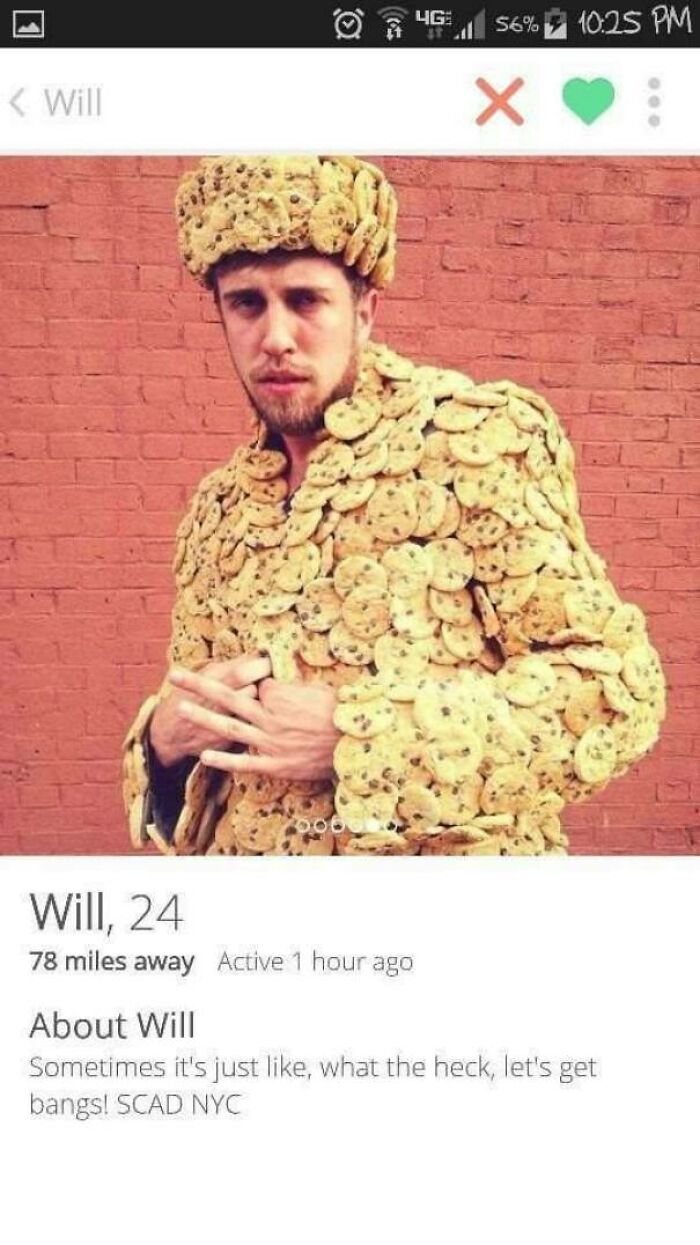 Man wearing a suit and hat covered in chocolate chip cookies in a funny Tinder profile picture.