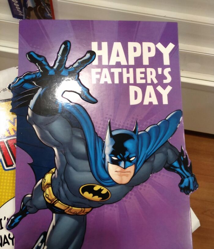Batman in a comic-style image reaching forward with text wishing a happy Father’s Day, capturing sarcastic image vibes.