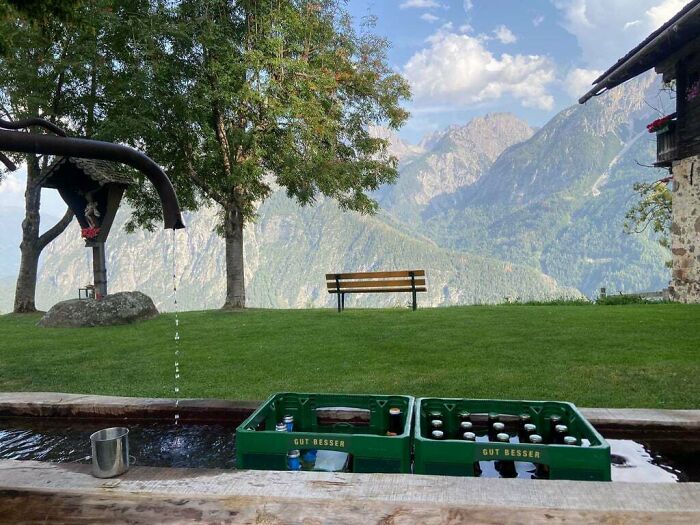 Crates of bottles being cooled in outdoor water, showcasing a genius idea to solve annoying problems with cooling.