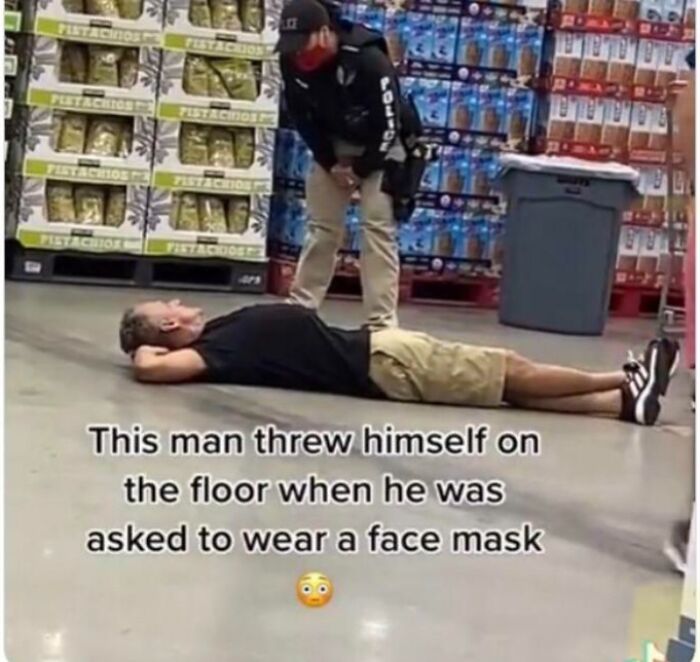 Man lying on the floor refusing to wear a face mask, a cringy and sad moment captured as a screenshot online.