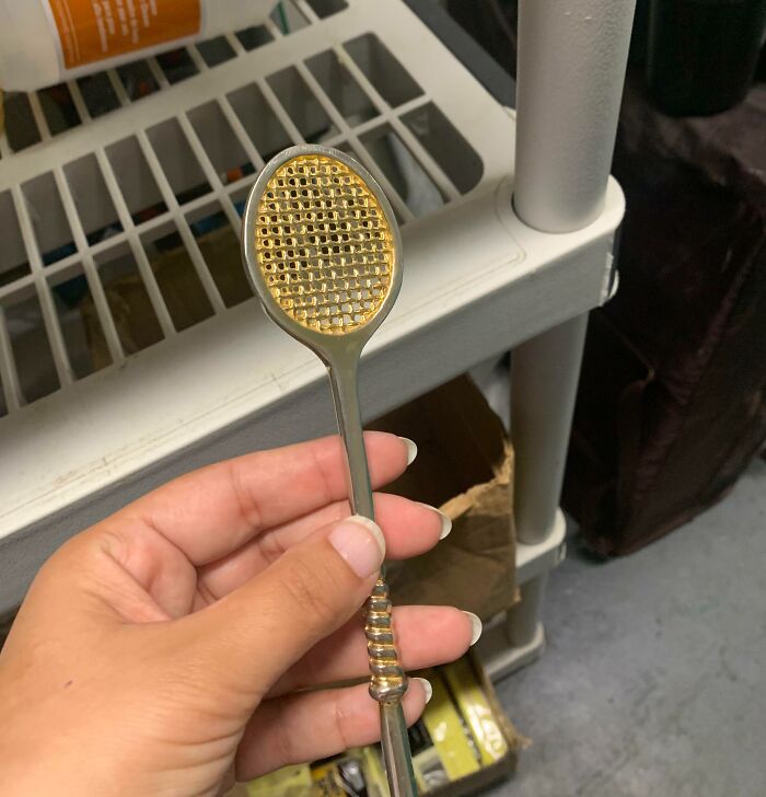 Hand holding a small metal object with a grid pattern, one of the unidentified objects solved by the internet mystery.