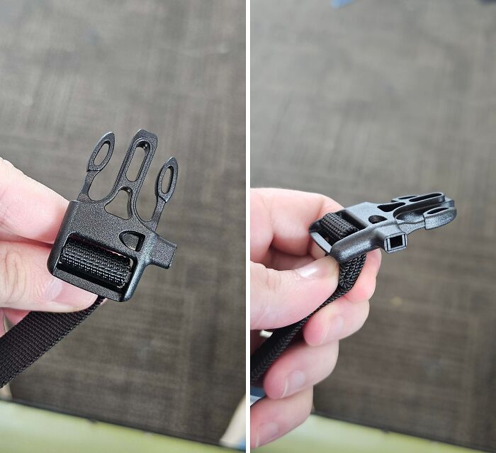 Close-up of an unidentified object held by hand, showcasing a unique plastic buckle with multiple loops and a strap.