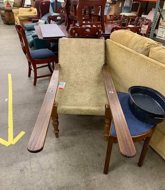 Unusual vintage wooden chair with extended armrests in a thrift store, one of many unidentified objects solved by the internet.
