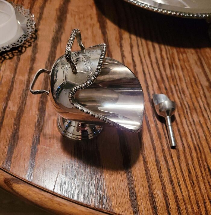 Silver vintage object on wood table, featured in 69 times the internet solved the mystery of unidentified objects.