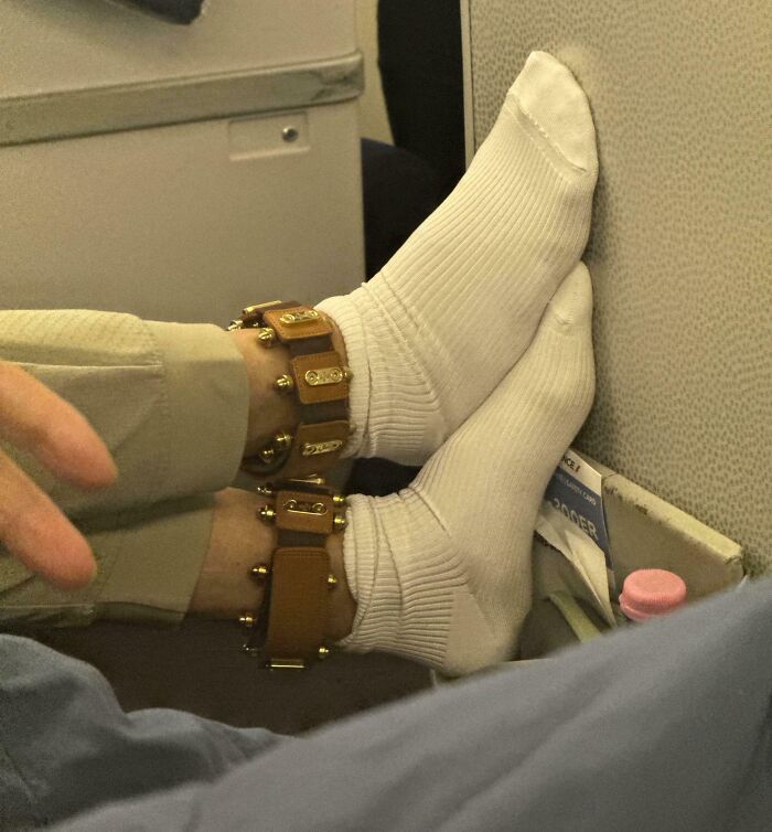 Close-up of feet wearing white socks and unusual ankle cuffs, an unidentified object solved by the internet mystery.
